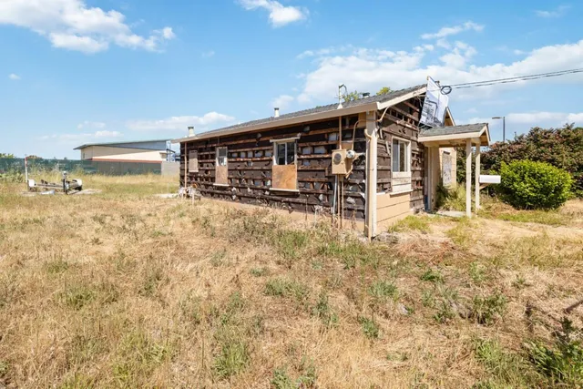 a view of a house with yard and sitting area