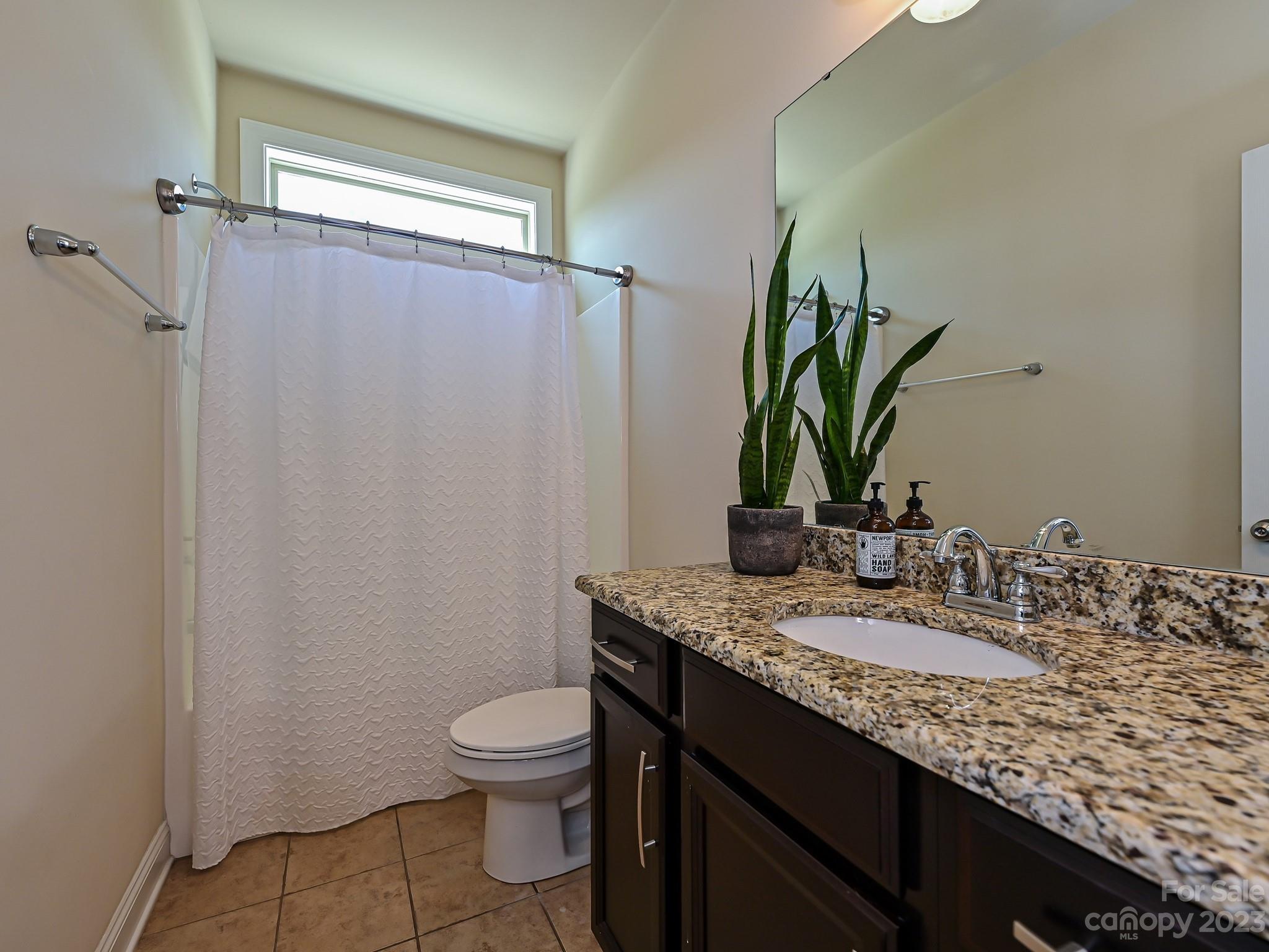 1012 Thorndale Road Indian Trail, NC 28079 - Photo 15 of 36 a bathroom with a granite countertop sink toilet and mirror