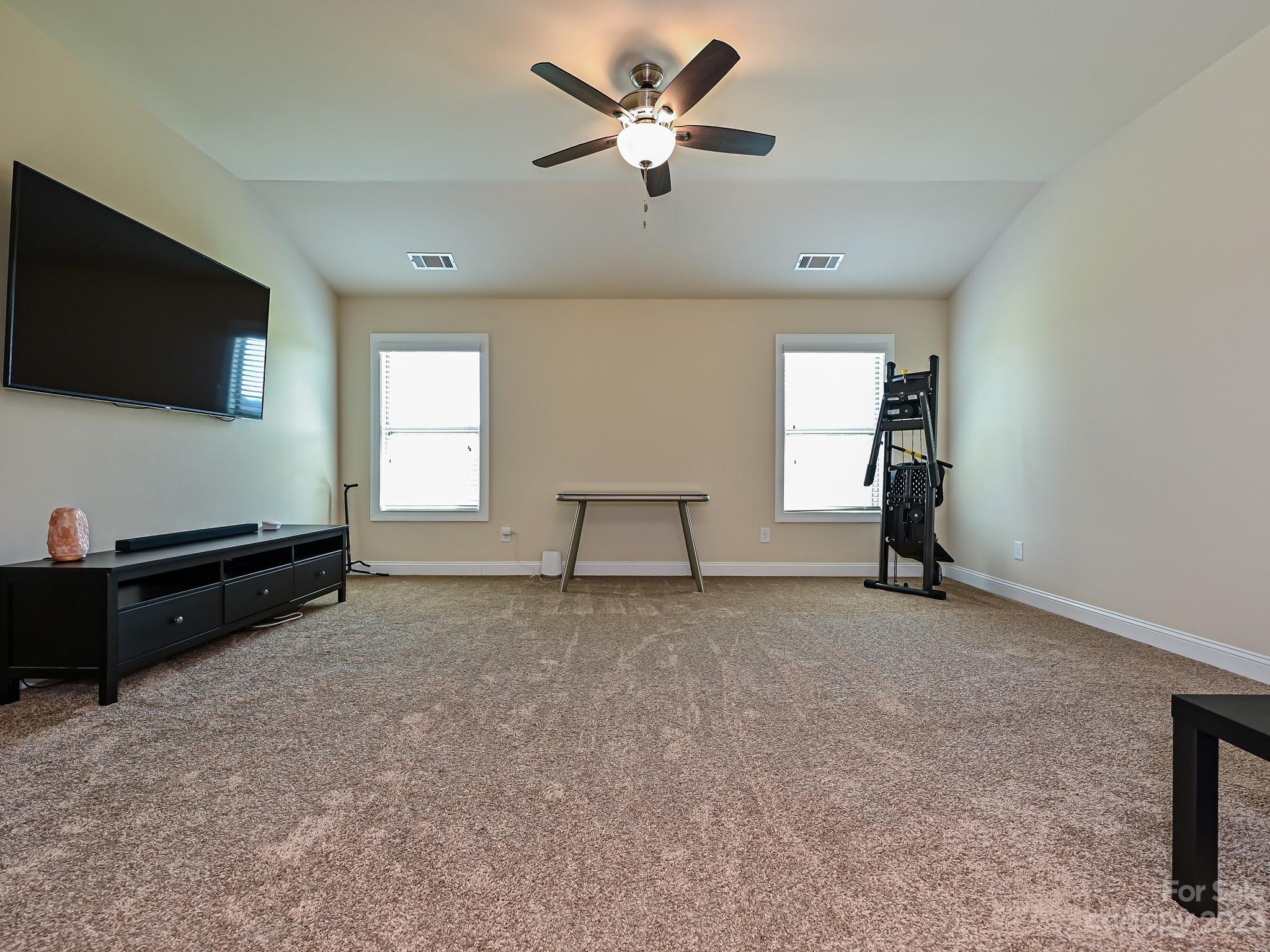 1012 Thorndale Road Indian Trail, NC 28079 - Photo 19 of 36 an empty room with windows and ceiling fan
