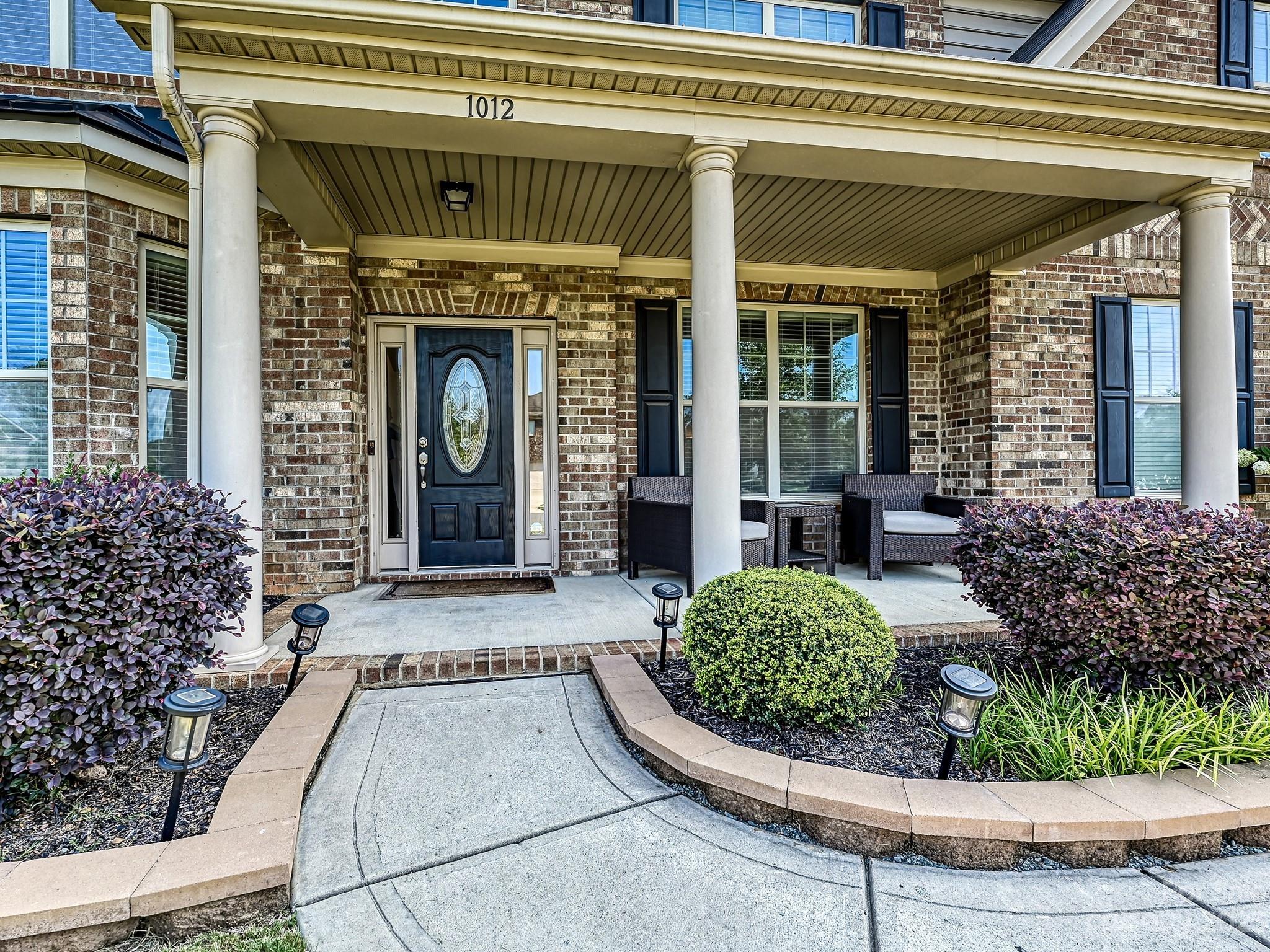 1012 Thorndale Road Indian Trail, NC 28079 - Photo 2 of 36 a view of a house with potted plants and more windows