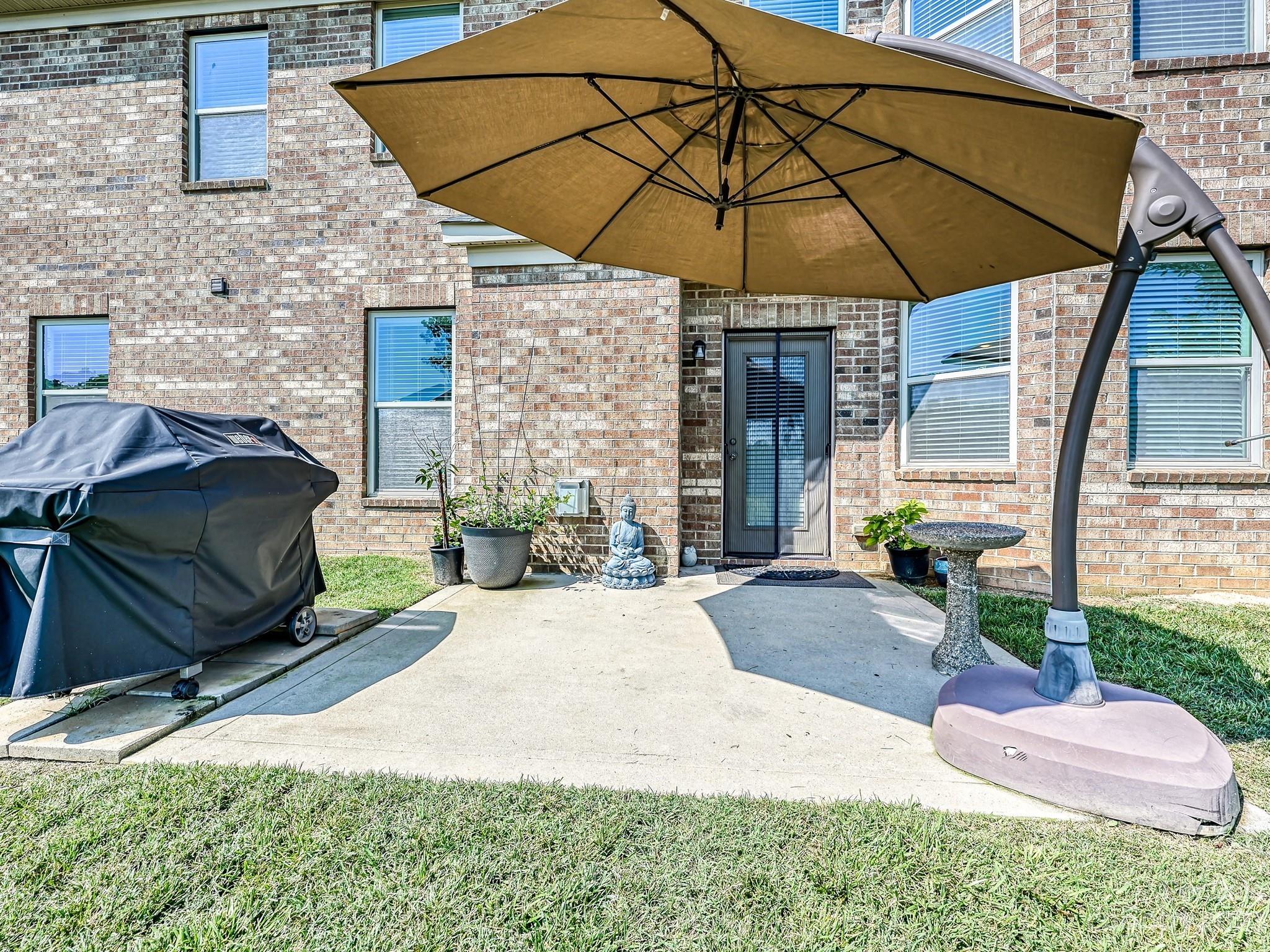 1012 Thorndale Road Indian Trail, NC 28079 - Photo 30 of 36 a yellow and red umbrella sitting in front of a house