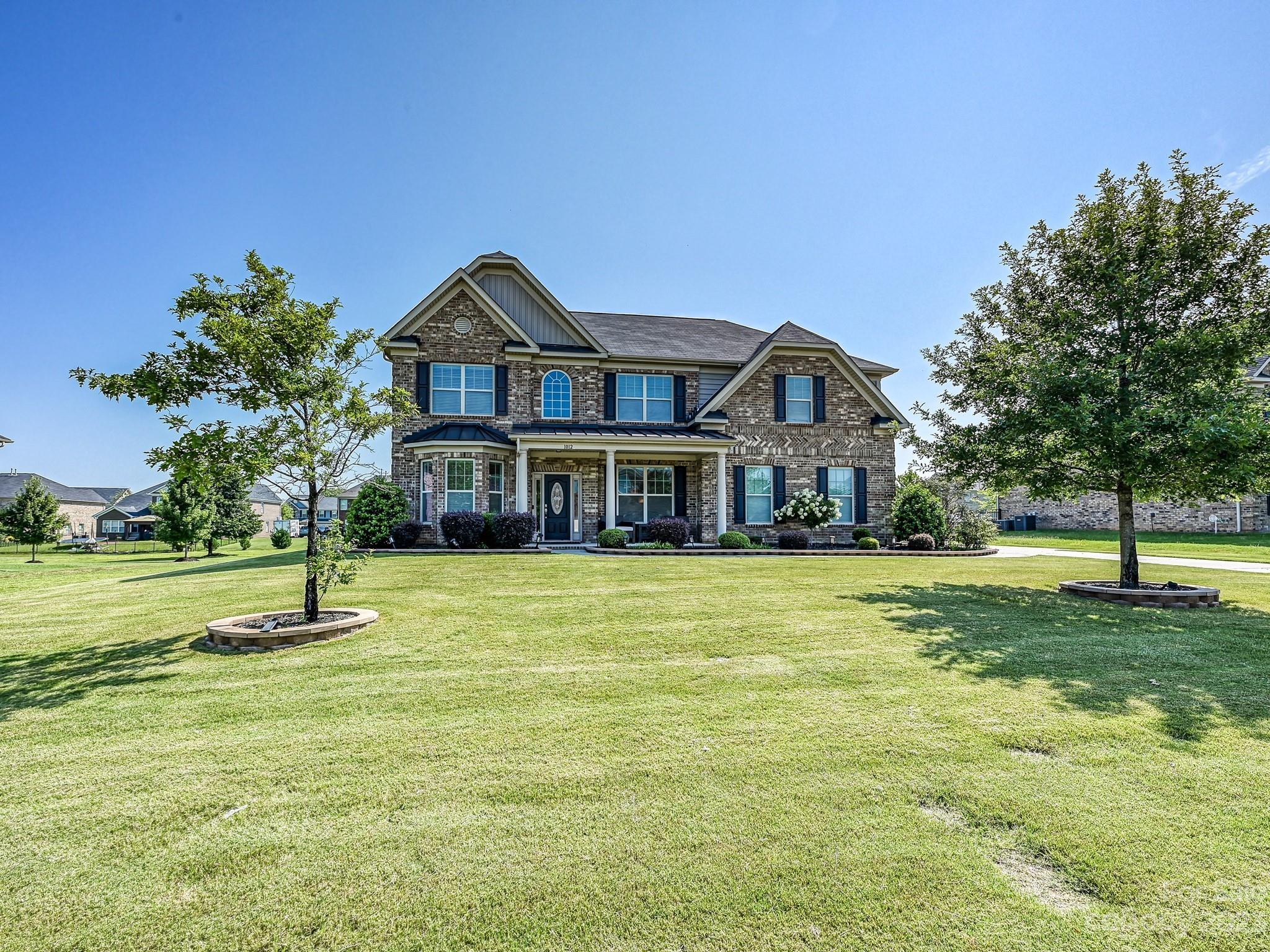 1012 Thorndale Road Indian Trail, NC 28079 - Photo 35 of 36 a front view of a house with a yard