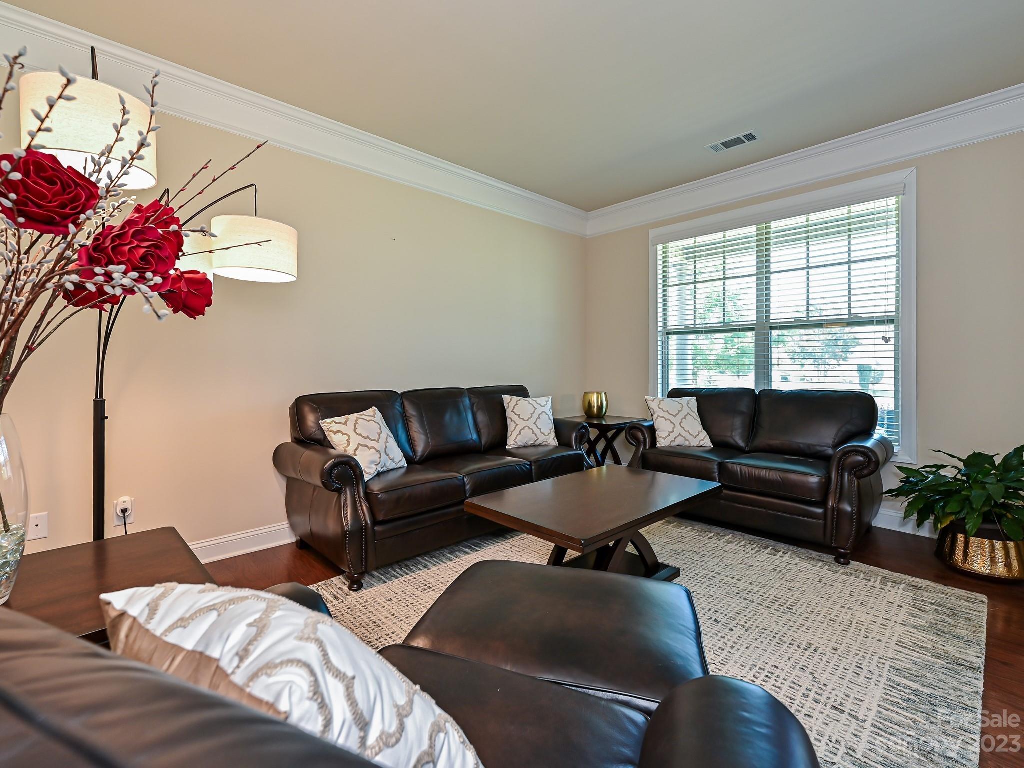 1012 Thorndale Road Indian Trail, NC 28079 - Photo 6 of 36 a living room with furniture and flowers