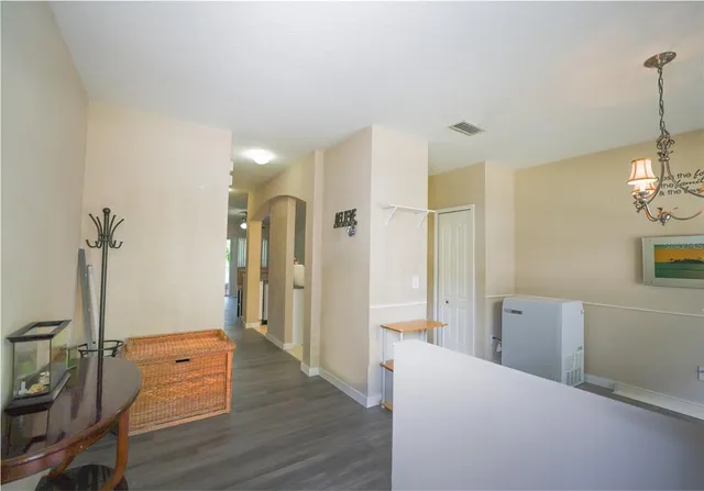 a view of a hallway view with wooden floor and staircase