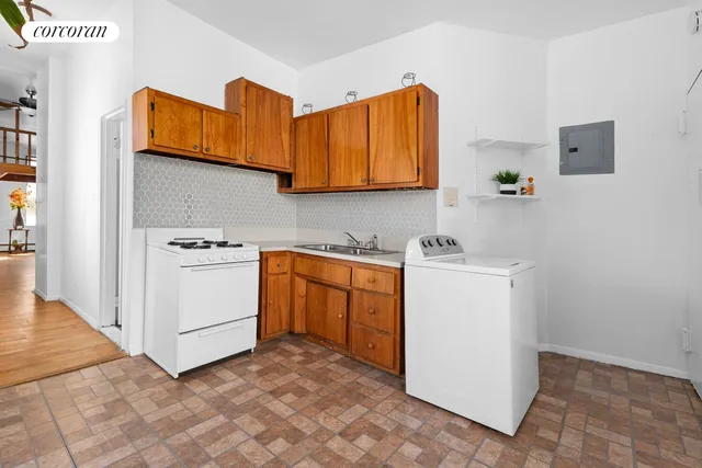 a bathroom with a sink and mirror with bathtub