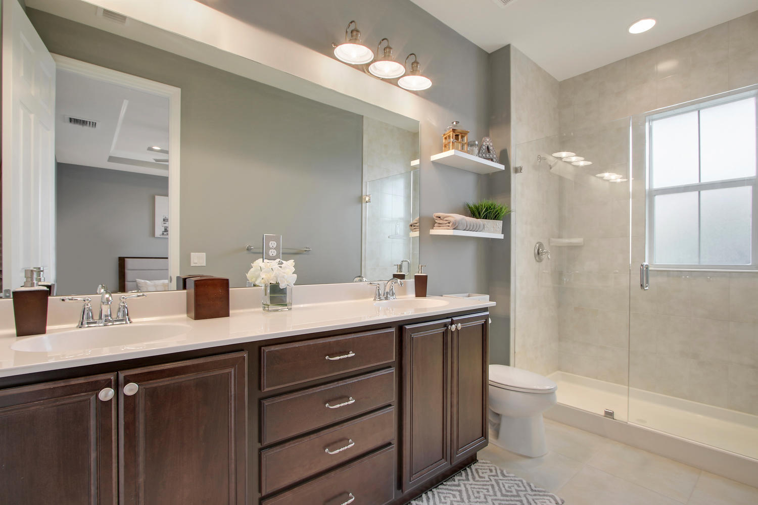 2706 Avalon Way Jupiter, FL 33458 - Photo 14 of 28 a bathroom with a granite countertop sink toilet mirror and bathtub
