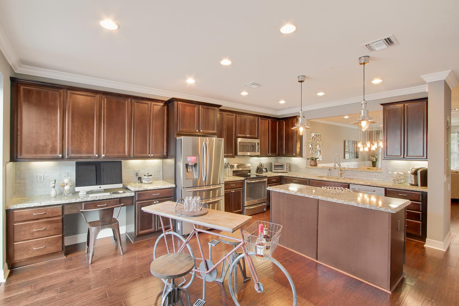2706 Avalon Way Jupiter, FL 33458 - Photo 4 of 28 a kitchen with stainless steel appliances kitchen island granite countertop a sink and cabinets