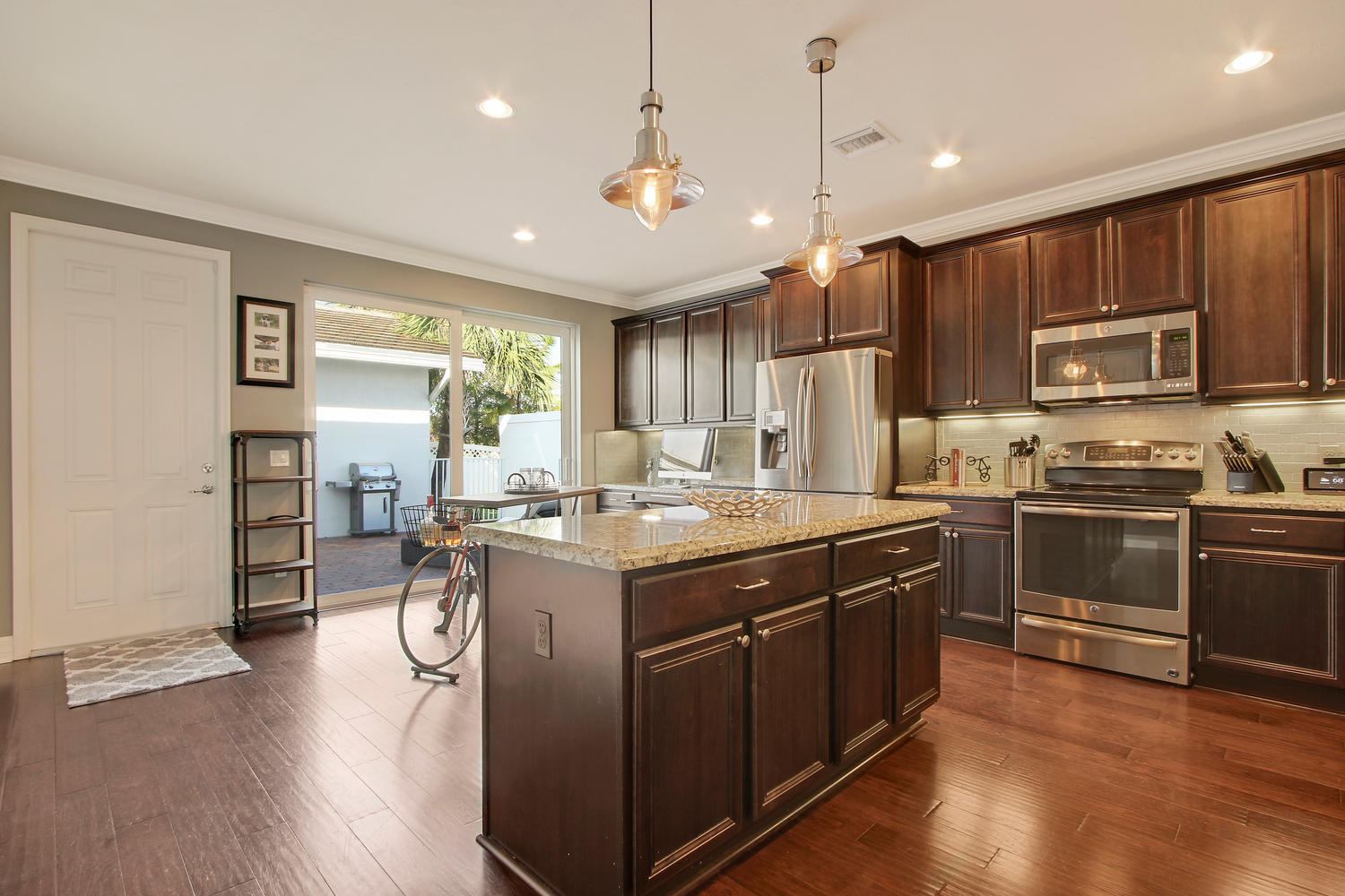2706 Avalon Way Jupiter, FL 33458 - Photo 5 of 28 a kitchen with kitchen island a counter top space a sink appliances and cabinets