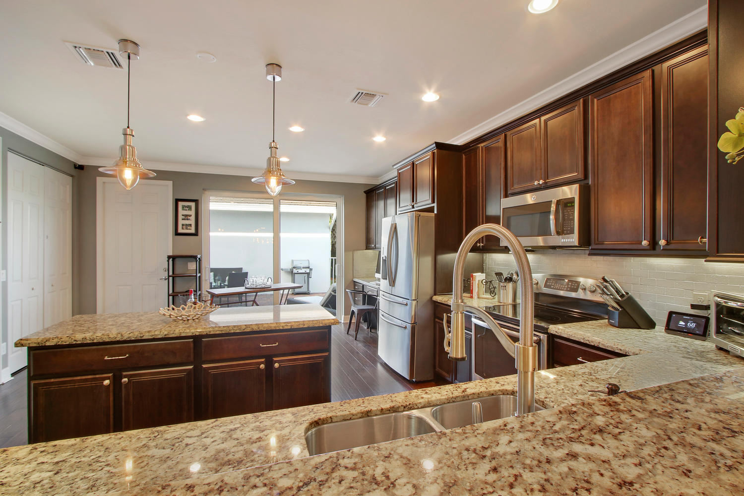 2706 Avalon Way Jupiter, FL 33458 - Photo 7 of 28 a kitchen with stainless steel appliances kitchen island granite countertop a sink stove and refrigerator
