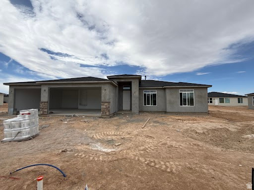 4973 North 970th East Enoch, UT 84721 - Photo 1 of 9 View of front of home featuring a garage and stucco siding