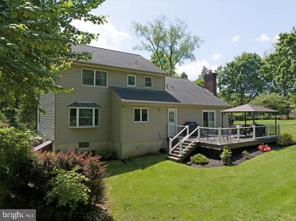 2581 Hill Road Reading, PA 19606 - Photo 6 of 53 a front view of a house with a garden and trees
