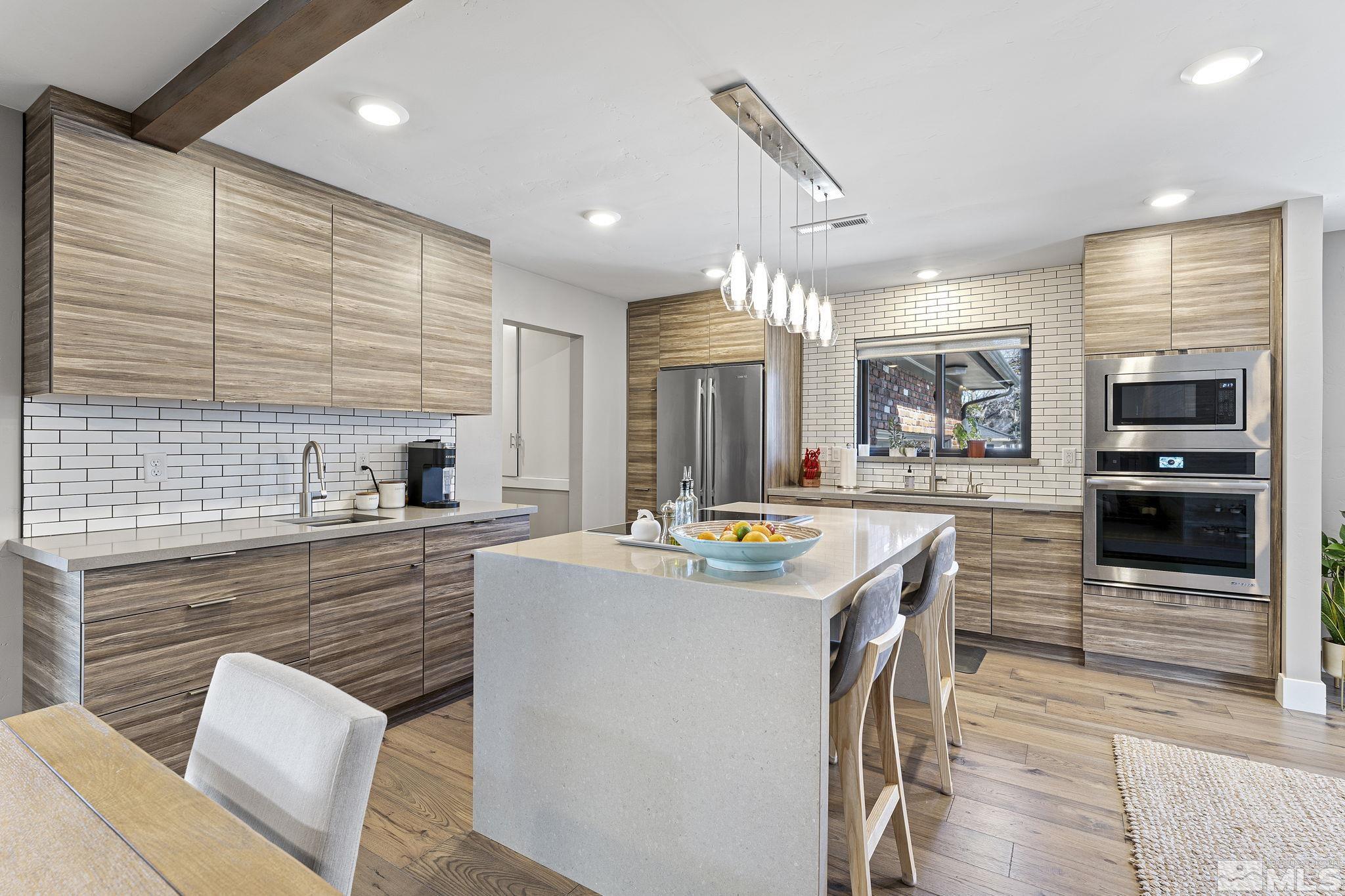 1085 Sharon Way Reno, NV 89509 - Photo 6 of 40 a large kitchen with kitchen island a large counter space and stainless steel appliances