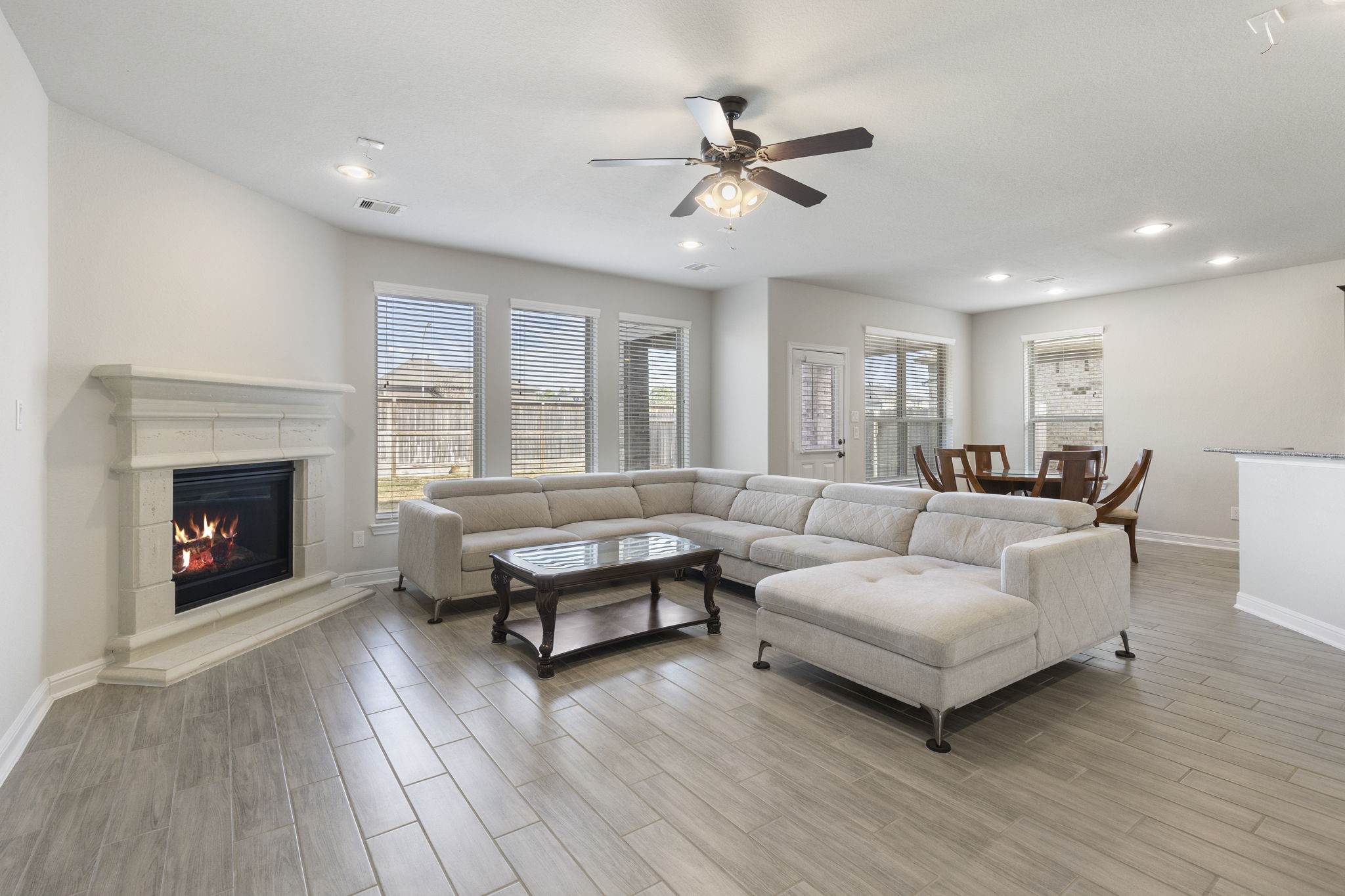 2819 Bradbury Hills Road Spring, TX 77373 - Photo 16 of 50 This inviting family room features a cozy fireplace, abundant natural light from expansive windows, and an open layout perfect for gatherings and relaxation.