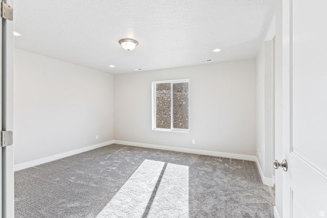 387 Slant Road, Unit 30 Spanish Fork, UT 84660 - Photo 15 of 25 Carpeted room featuring a single window, recessed lighting, a ceiling-mounted light fixture, and white baseboards