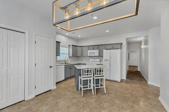 a kitchen with a table and chairs