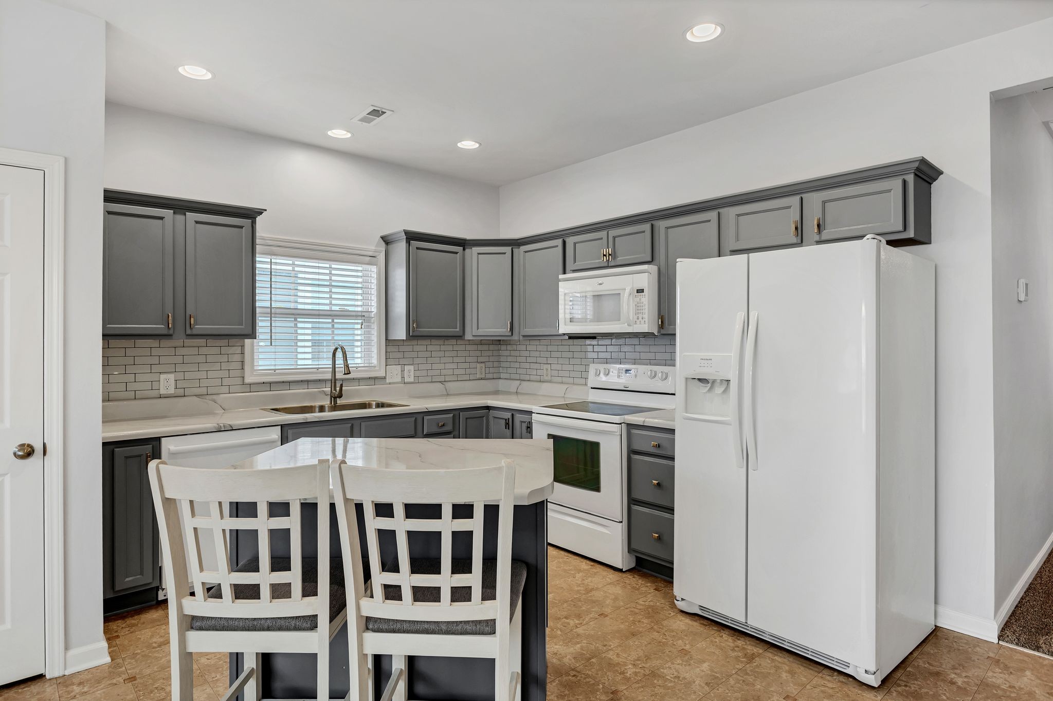 1019 Briggs Lane Spring Hill, TN 37174 - Photo 13 of 40 a kitchen with stainless steel appliances a stove a sink and a refrigerator