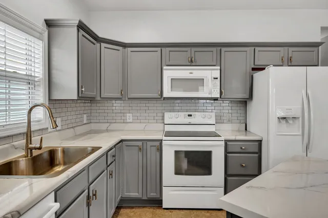 a kitchen with a sink cabinets and stainless steel appliances