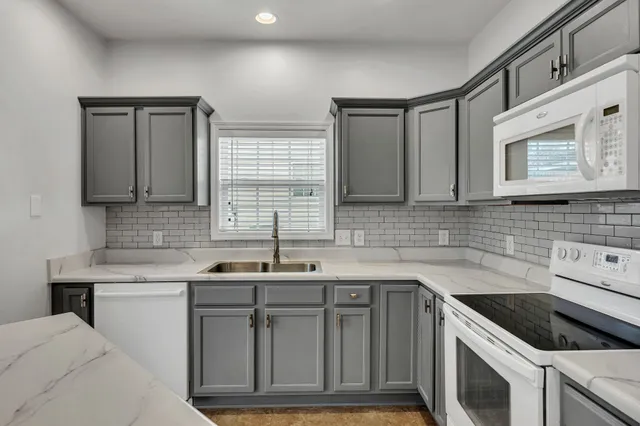 a kitchen with stainless steel appliances granite countertop a sink stove and cabinets