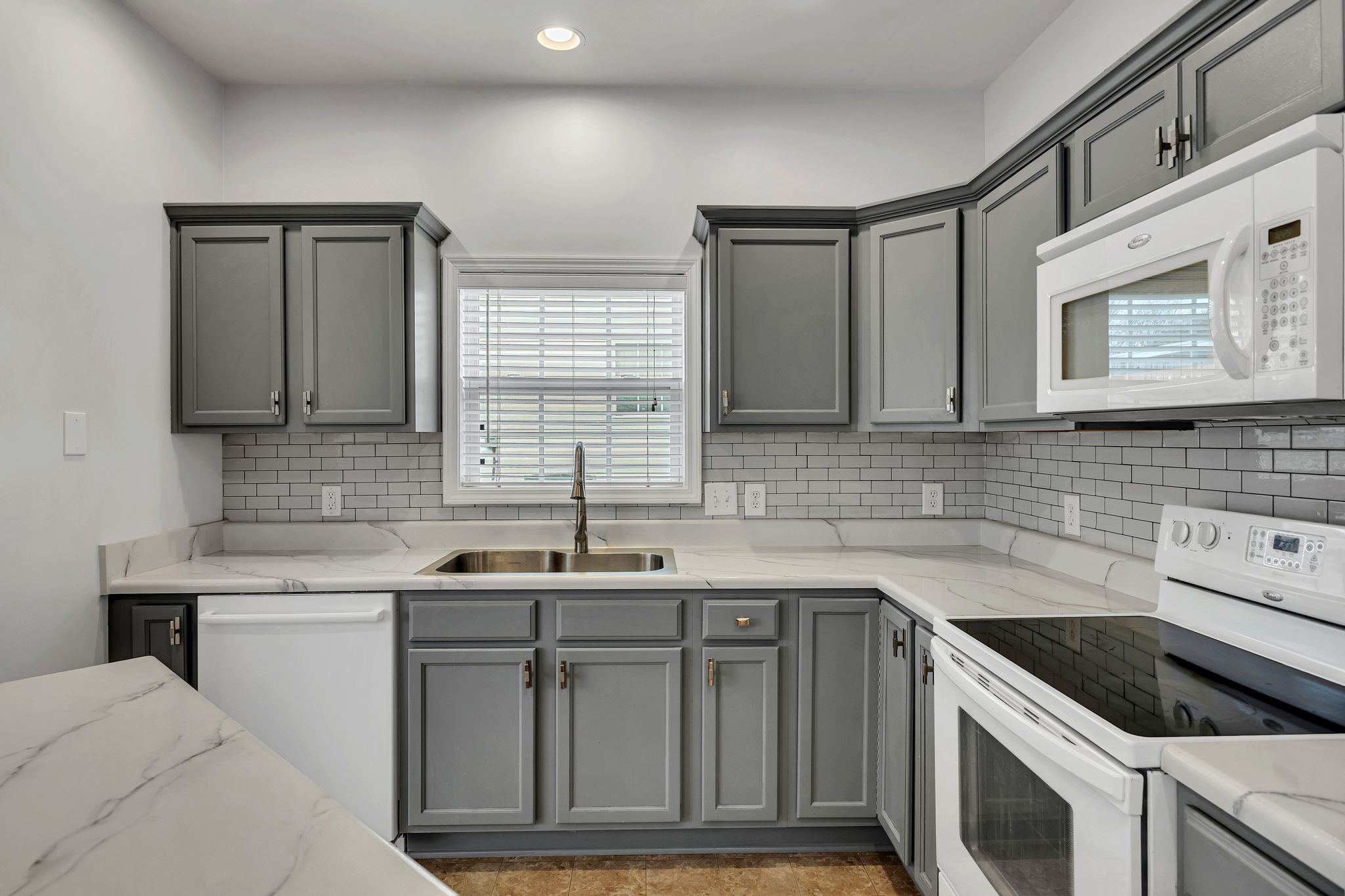 1019 Briggs Lane Spring Hill, TN 37174 - Photo 15 of 40 a kitchen with stainless steel appliances granite countertop a sink stove and cabinets