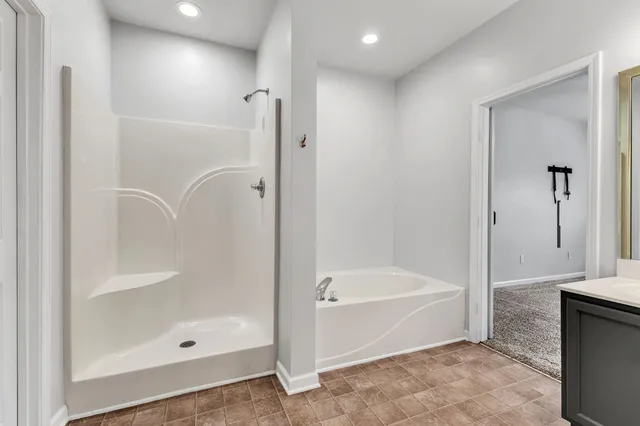 a bathroom with a bathtub and a shower