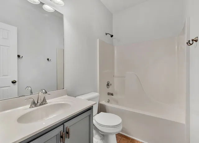 a bathroom with a sink toilet vanity and shower