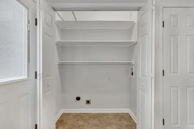 a view of walk in closet with empty racks