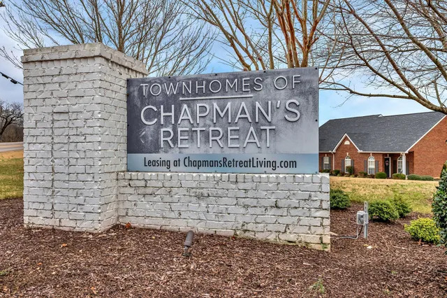 a brick building with a sign broad