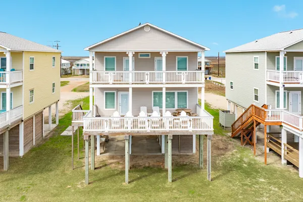a view of a house with a porch and furniture