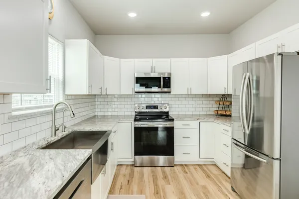 a kitchen with a sink stove and refrigerator