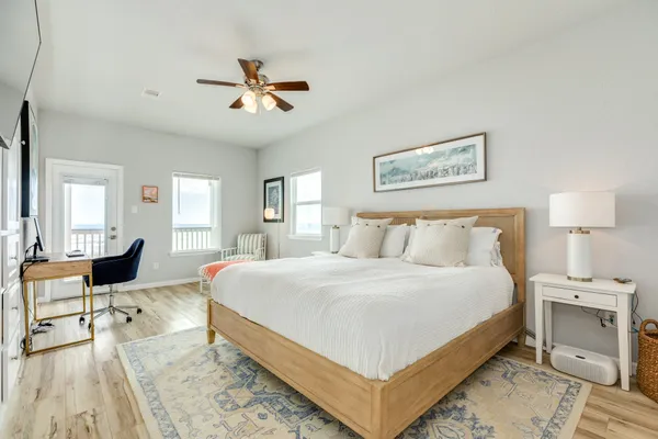 a bedroom with a bed and a dresser with rug