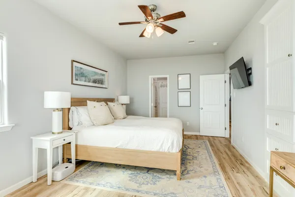 a bedroom with a bed and a chandelier