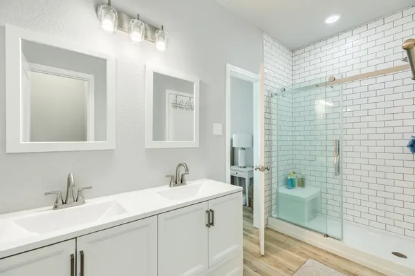 a bathroom with a sink double vanity and shower