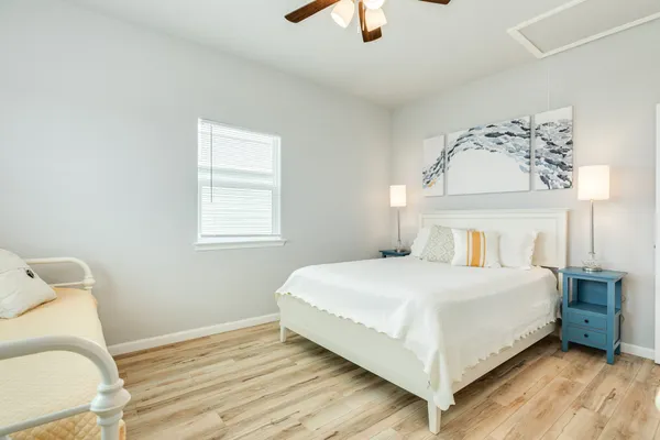 a bedroom with a bed and a chandelier
