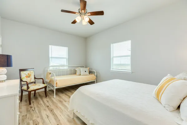 a bedroom with a bed and a chandelier