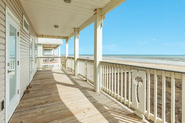 a view of a balcony with wooden floor