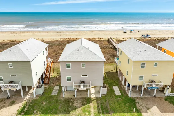 an aerial view of a house with a ocean view