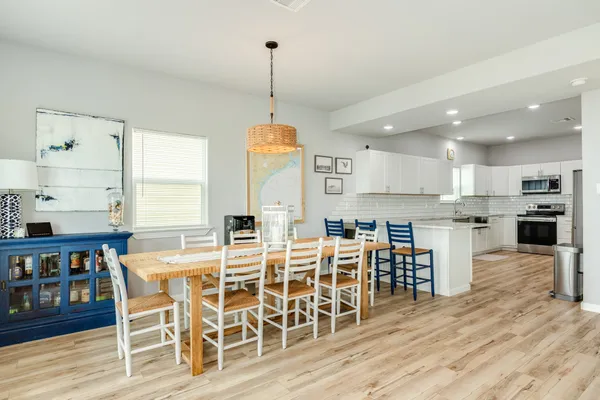 a view of a kitchen with kitchen island dining table and wooden floor