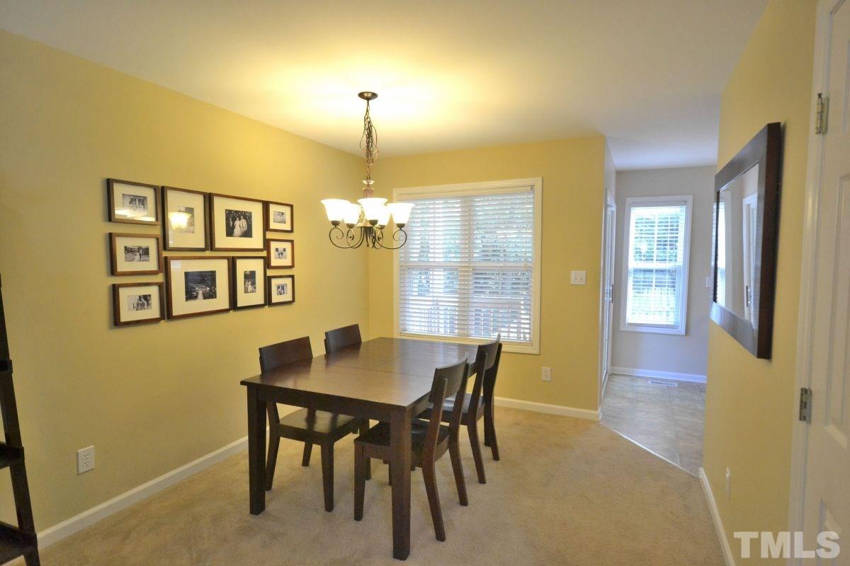 2908 Englefield Drive Raleigh, NC 27615 - Photo 3 of 16 a view of a dining room with a table and chairs