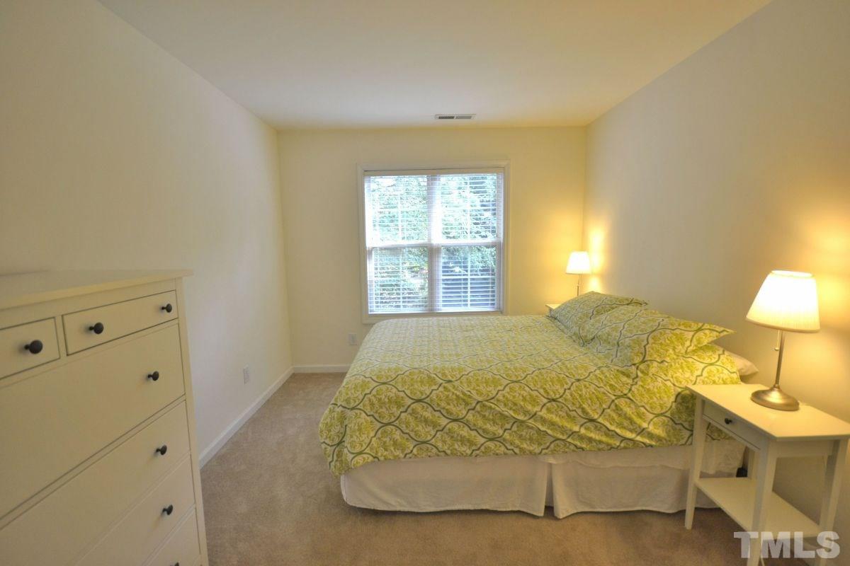 2908 Englefield Drive Raleigh, NC 27615 - Photo 6 of 16 a bed sitting in a bedroom next to a window