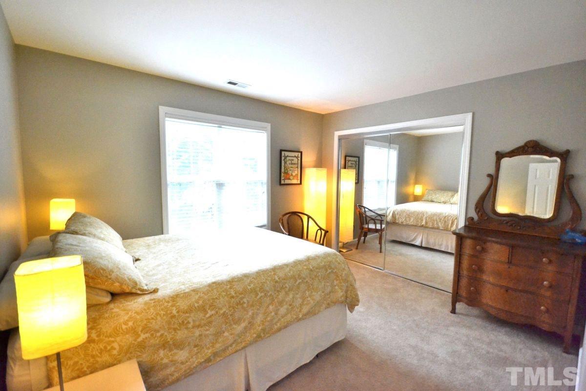 2908 Englefield Drive Raleigh, NC 27615 - Photo 7 of 16 a bedroom with a bed and dresser with mirror