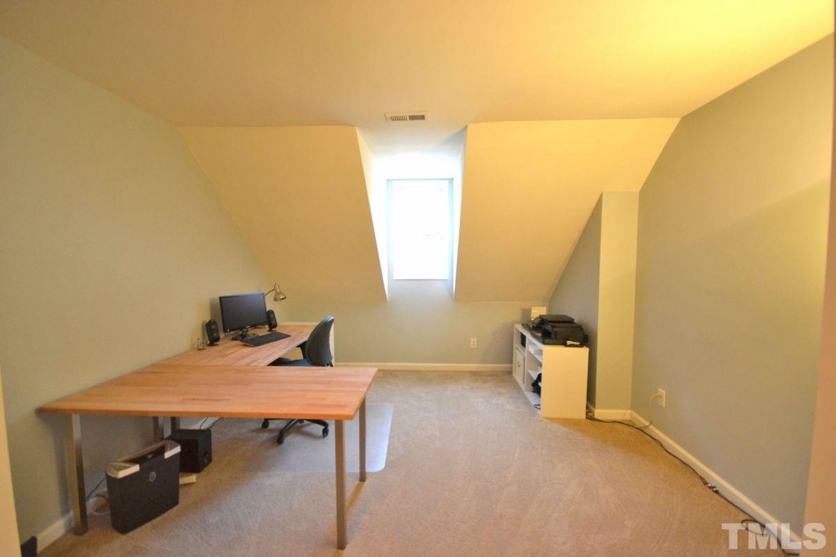 2908 Englefield Drive Raleigh, NC 27615 - Photo 10 of 16 a view of a workspace with furniture and a window