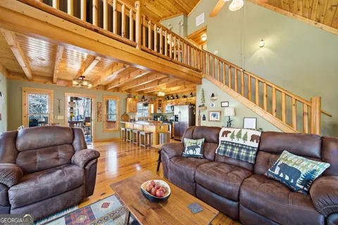 a living room with furniture and a ceiling fan
