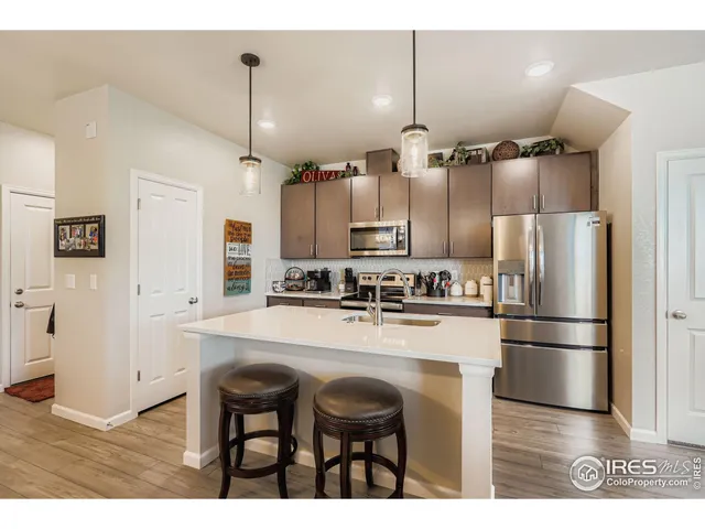 a kitchen with refrigerator cabinets and wooden floor