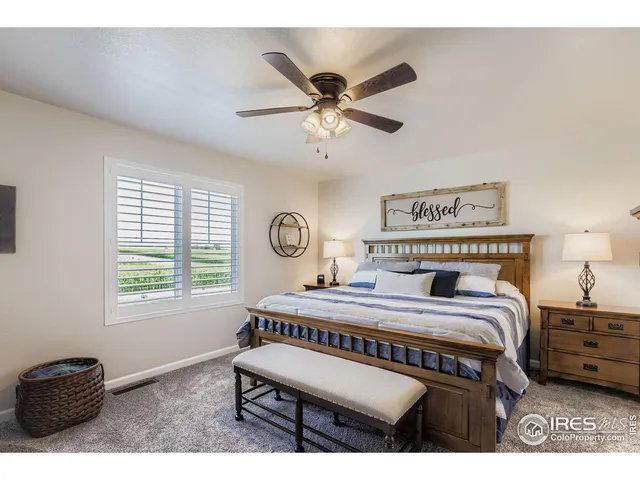 a bedroom with a bed a dresser and a window