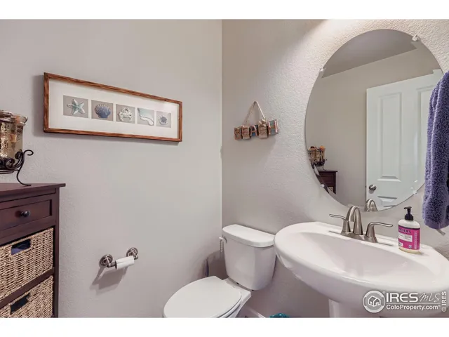 a bathroom with a sink mirror vanity and toilet