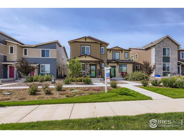 a front view of a residential apartment building with a yard