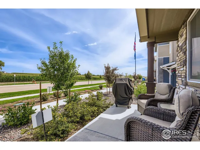a view of a chairs and table in patio with a yard