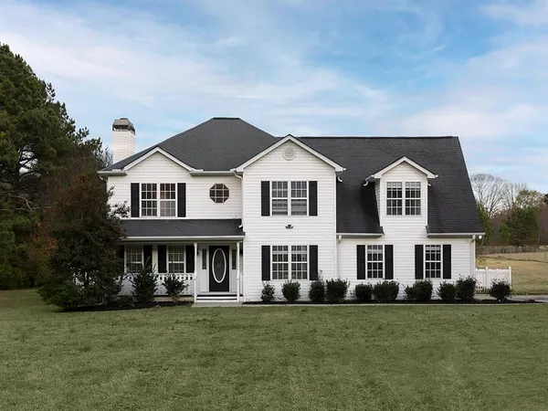 a front view of a house with a garden