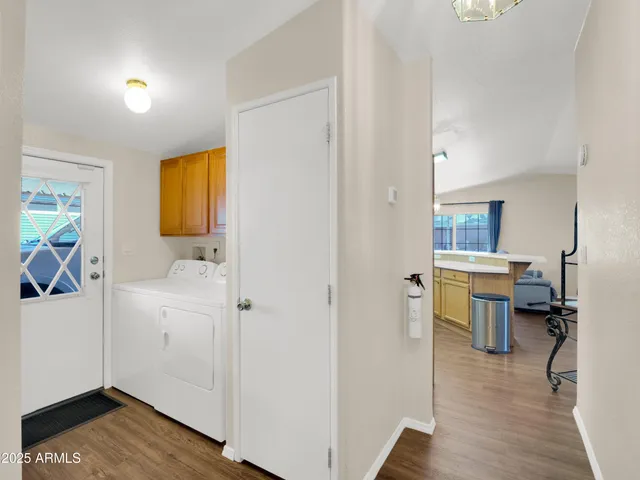 a view of a study room with wooden floor and a window