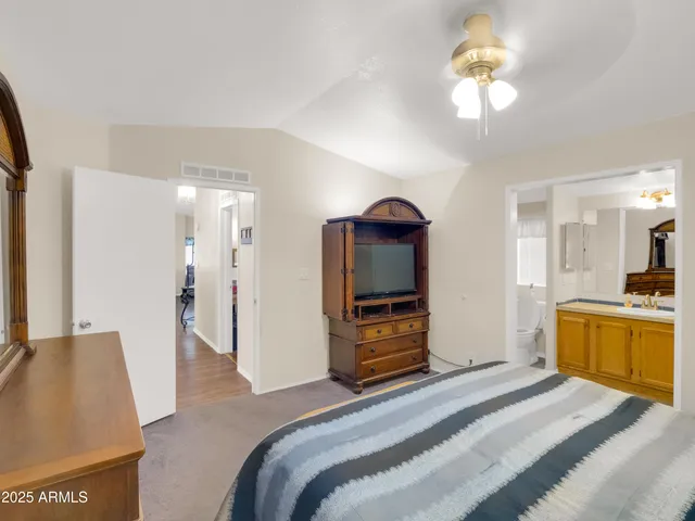 a bedroom with a bed and a television